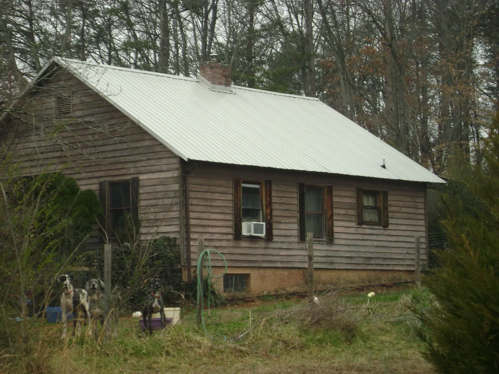 White metal roof on an old wood sided farmhouse, from a Metal Roof Installation job in Edgar